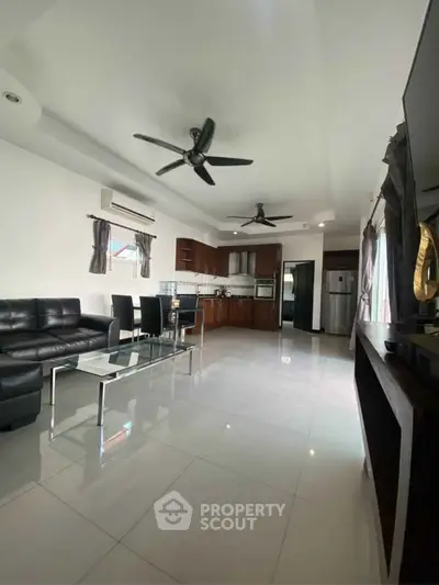 Spacious modern living room with open kitchen and sleek furnishings