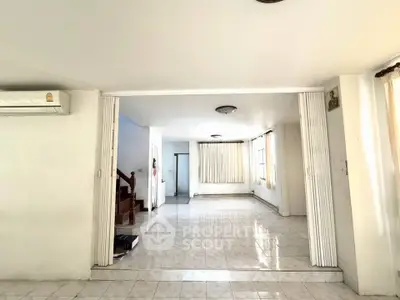 Spacious open living area with tiled floors and natural light