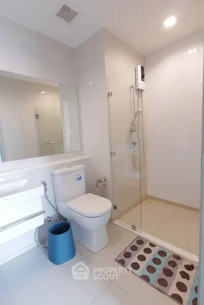 Modern bathroom with glass shower and sleek fixtures