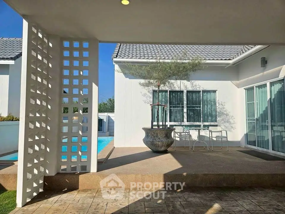 Modern villa exterior with pool and stylish patio area, perfect for luxury living.