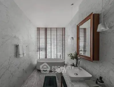 Luxurious marble bathroom with freestanding bathtub and elegant fixtures