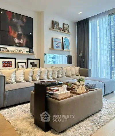 Modern living room with stylish decor, large windows, and cozy seating area.