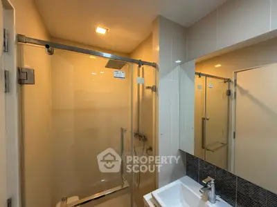 Modern bathroom with glass shower and sleek fixtures