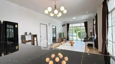 Spacious modern living room with elegant lighting and garden view, perfect for family gatherings.