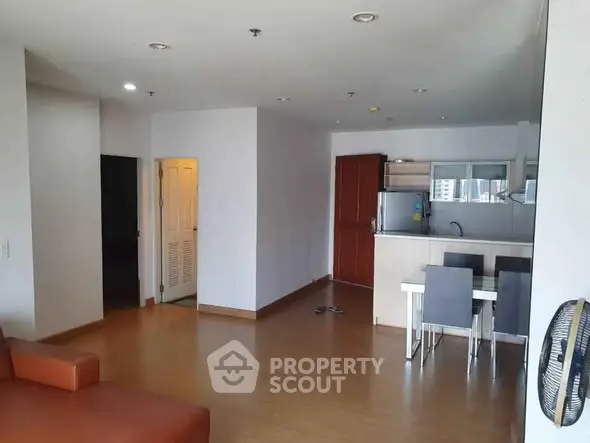 Spacious open-plan living room with modern kitchen and dining area.