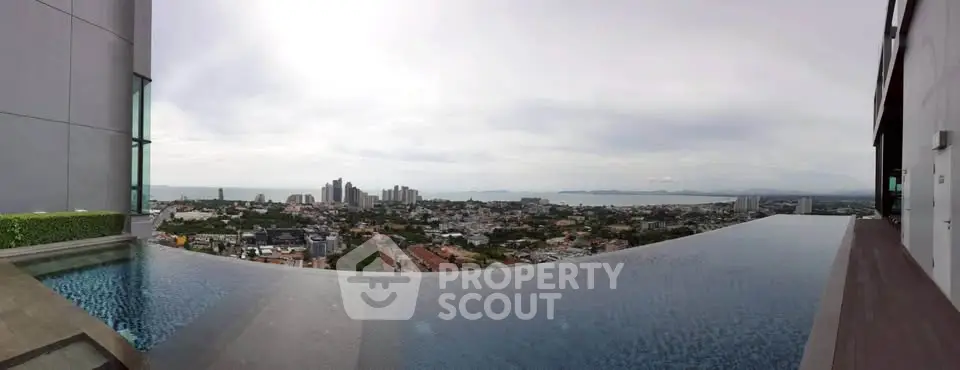 Stunning rooftop infinity pool with panoramic city and ocean views, perfect for luxury living.