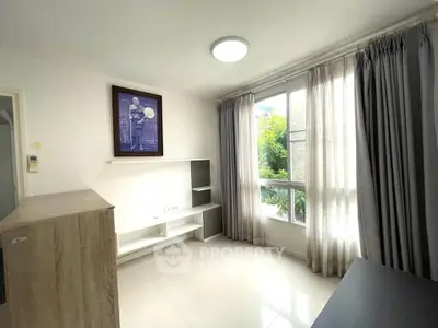 Bright living room with large window and modern decor in a stylish apartment.