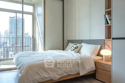 Modern bedroom with city view and stylish decor in high-rise apartment