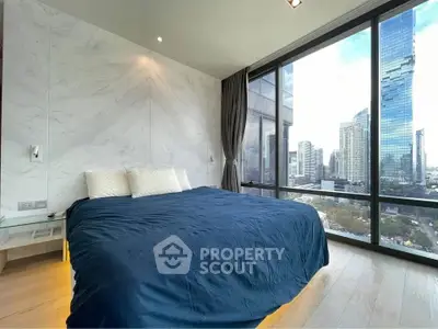 Luxurious bedroom with stunning city view and modern design in high-rise apartment.