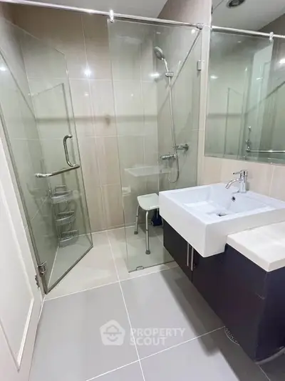 Modern bathroom with glass shower and sleek sink design