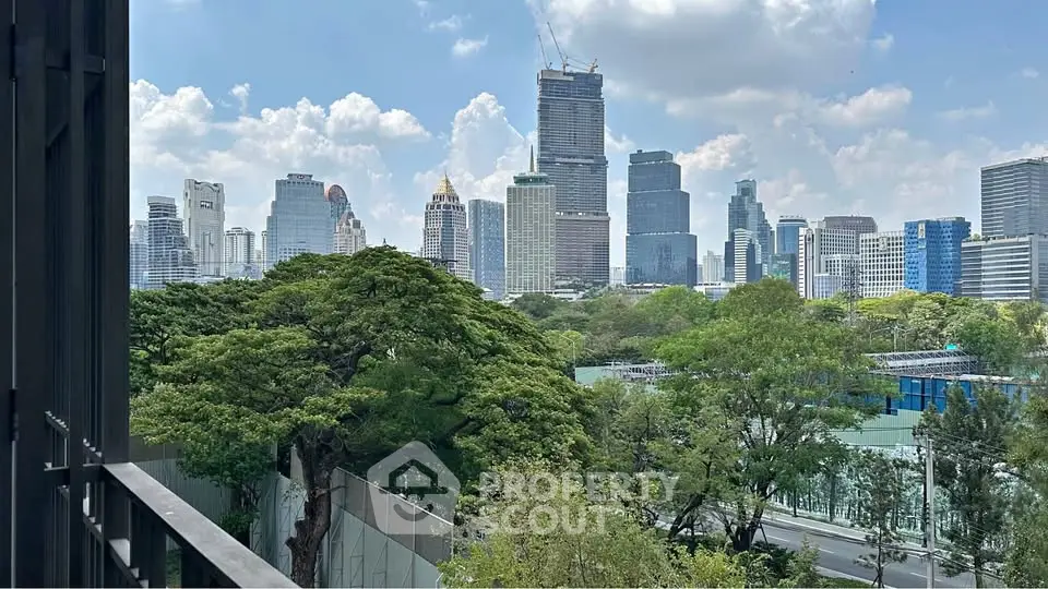 Stunning cityscape view from a balcony overlooking lush greenery and modern skyscrapers.