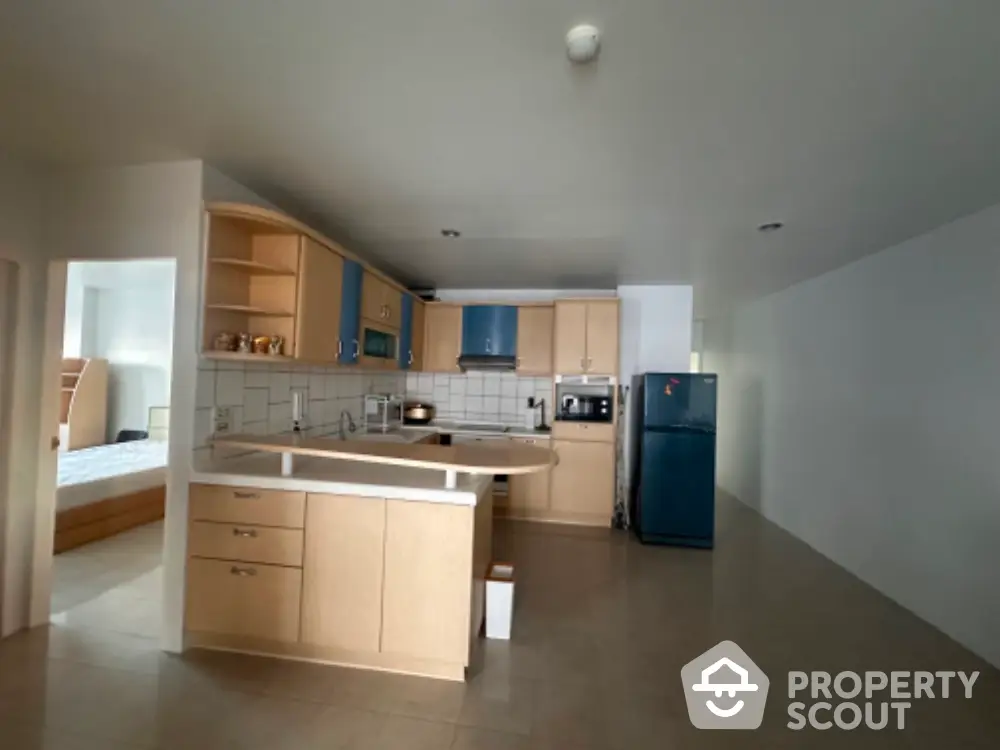 Spacious kitchen with modern appliances and open layout adjacent to bedroom