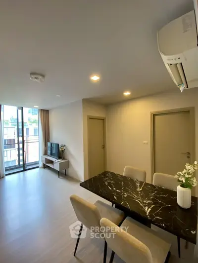 Modern living room with dining area and large windows in a stylish apartment