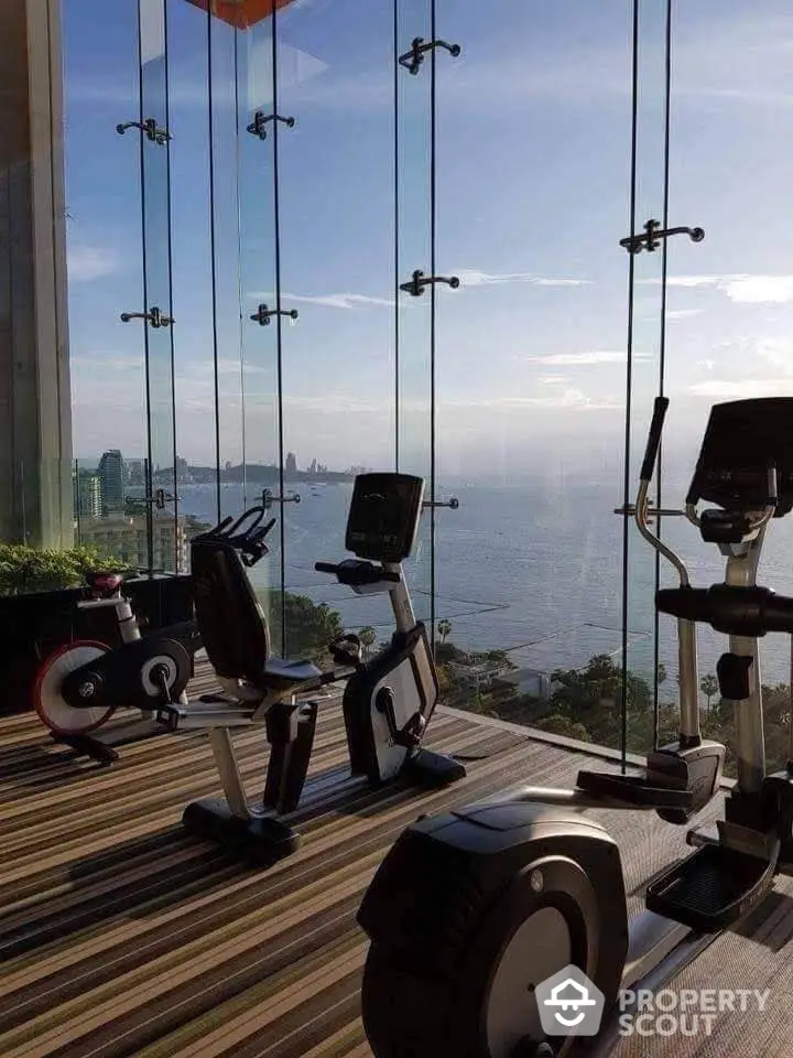 Stunning gym with panoramic ocean view and modern exercise equipment