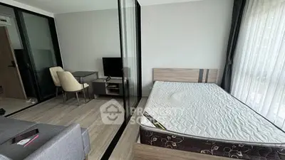 Modern studio apartment with glass partition and minimalist furnishings