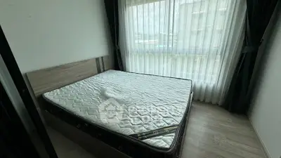 Spacious bedroom with large window and natural light