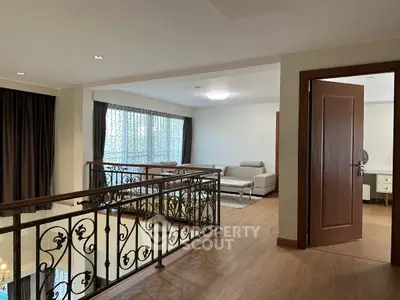 Elegant living room with stylish railing and modern furniture in a spacious interior setting.