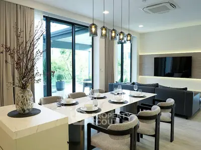 Luxurious modern living room with elegant dining area and garden view