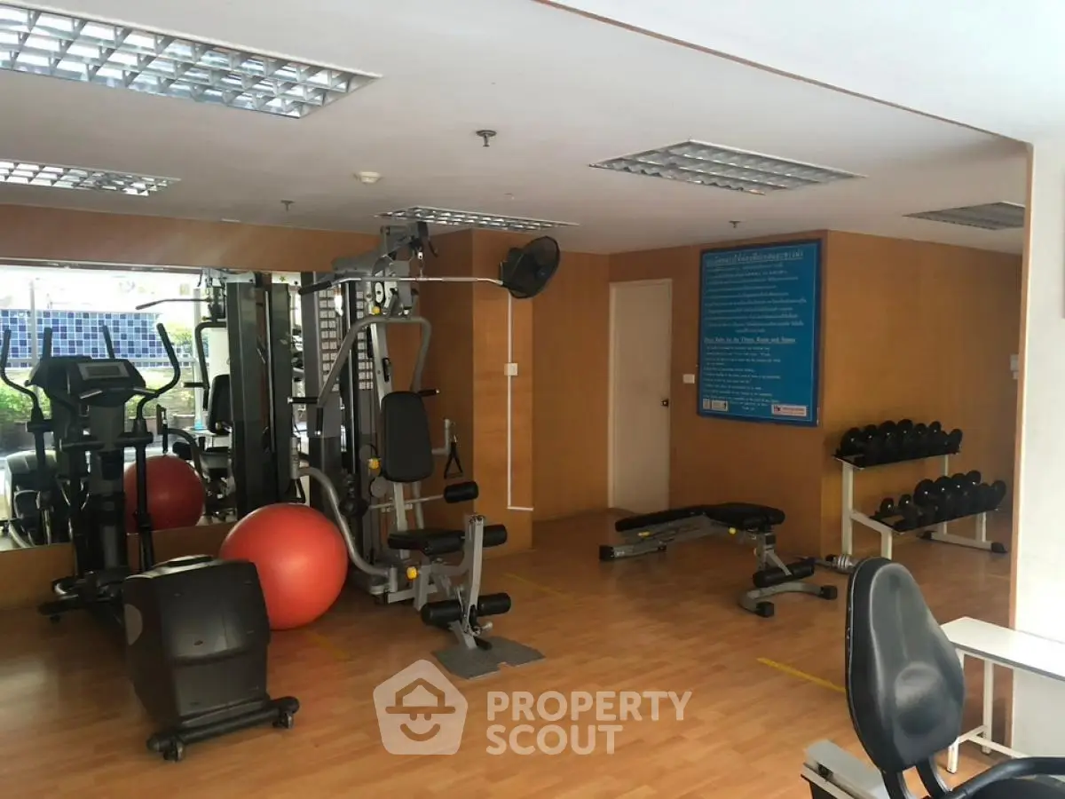 Spacious gym with modern equipment in residential building
