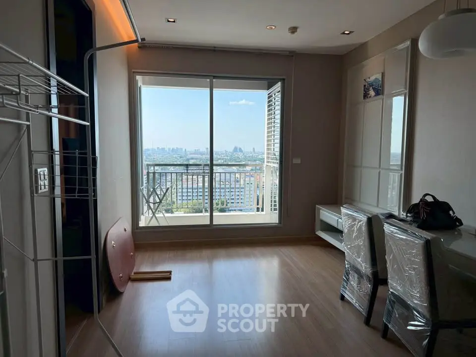 Spacious living room with city view and balcony access in modern apartment