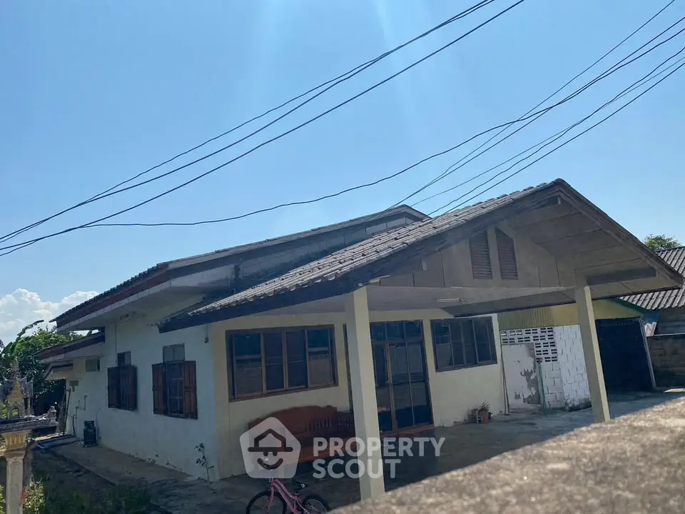 Charming single-story house with spacious front porch and traditional design, perfect for family living.