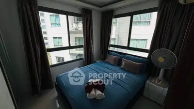 Cozy bedroom with large windows and modern decor in urban apartment
