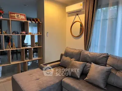 Cozy living room with modern gray sofa and stylish decor
