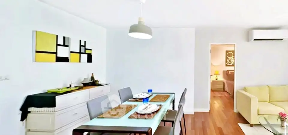 Modern dining area with stylish decor and open view to cozy living room