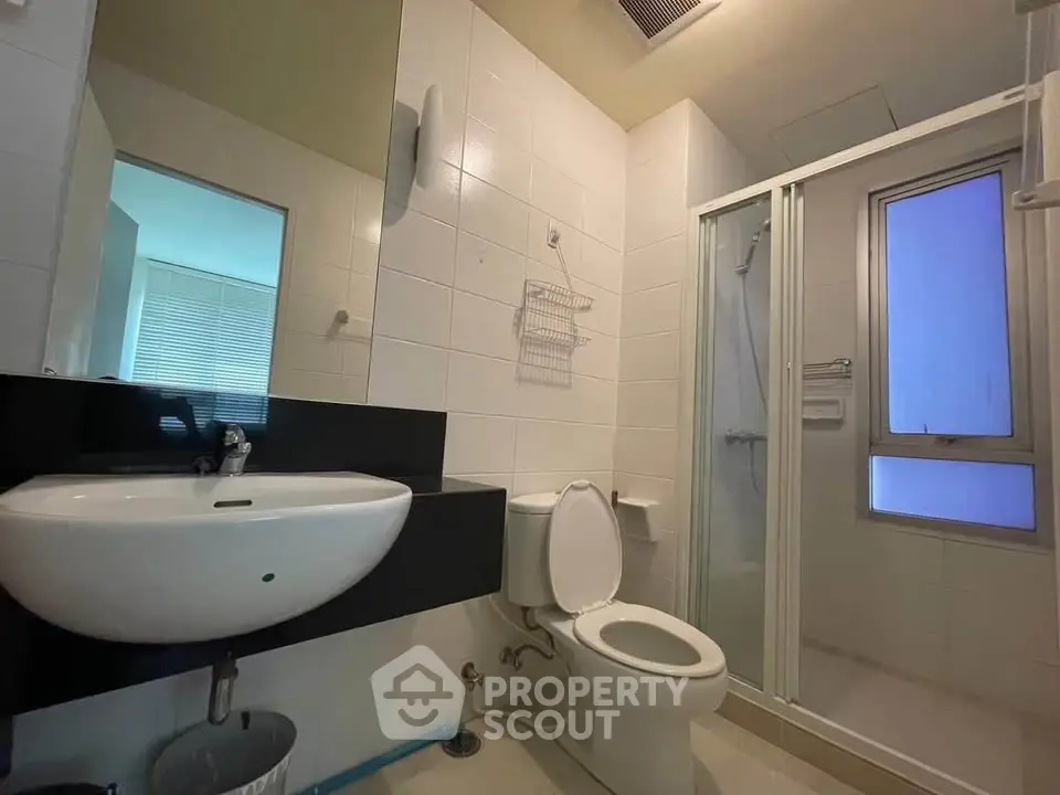 Modern bathroom with sleek fixtures and glass shower enclosure