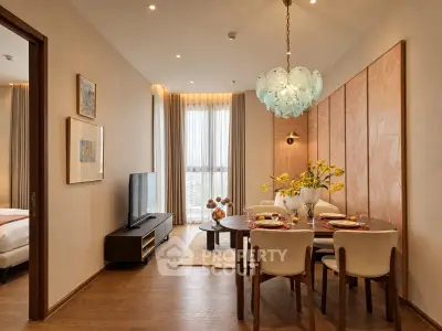 Elegant living room with dining area, modern decor, and large window view
