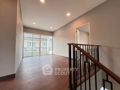 Spacious modern living room with wooden flooring and large windows
