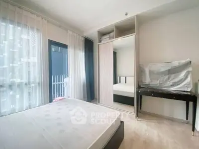 Bright bedroom with balcony access and built-in wardrobe