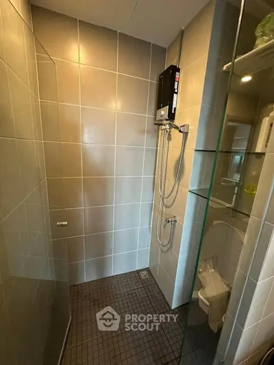 Modern bathroom with sleek tiles and glass shower enclosure