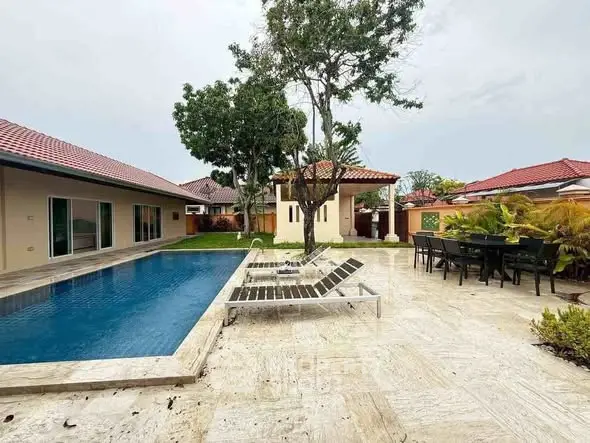 Luxurious villa with private pool and spacious patio in tropical setting.