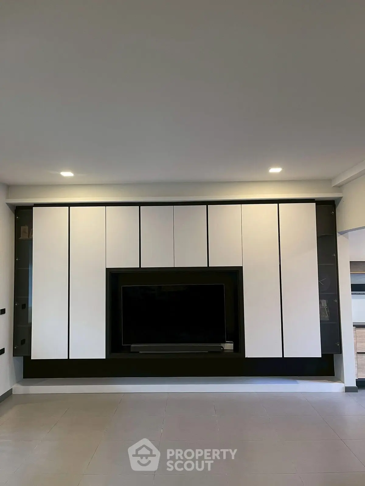 Modern living room with sleek built-in entertainment center and minimalist design.