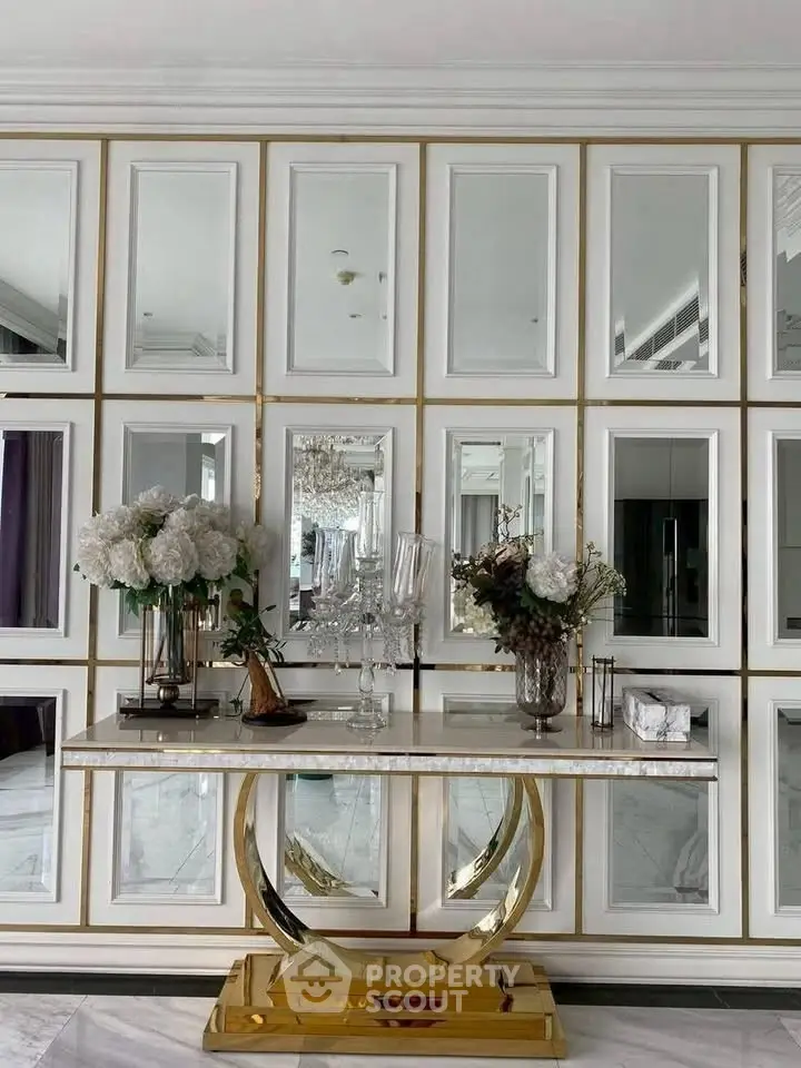 Luxurious interior with elegant console table and mirrored wall, perfect for sophisticated living spaces.