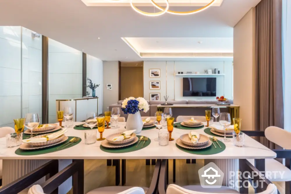 Luxurious dining room with elegant table setting and modern lighting in a spacious open-plan living area.