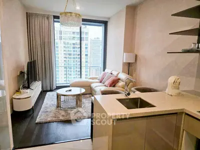 Modern living room with city view, elegant decor, and open kitchen layout.