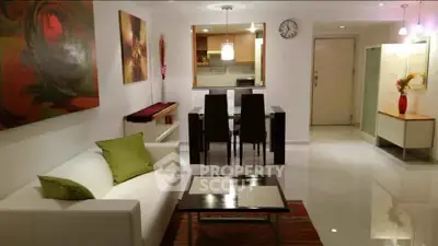 Modern living room with sleek furniture and open kitchen layout, perfect for stylish urban living.