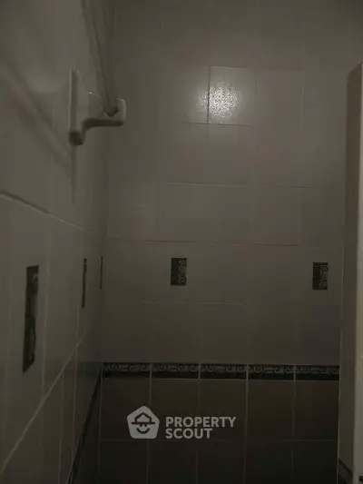 Simple bathroom with tiled walls and minimalistic design