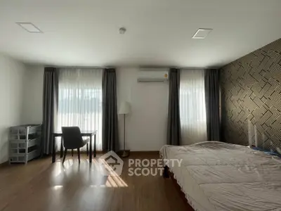Spacious bedroom with modern decor and natural light
