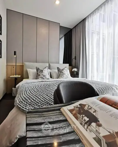 Luxurious modern bedroom with large windows and stylish decor, perfect for relaxation and comfort.