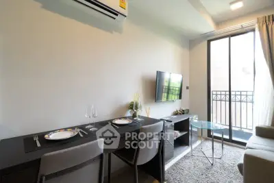Modern living room with dining area and balcony access in stylish apartment.