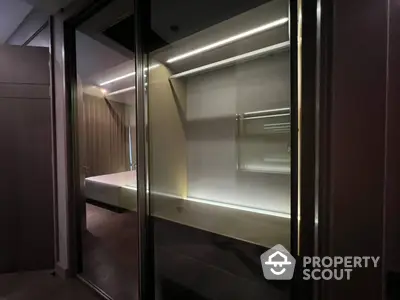 Sleek modern walk-in closet with ample shelving and integrated lighting, perfect for organizing a luxurious wardrobe.