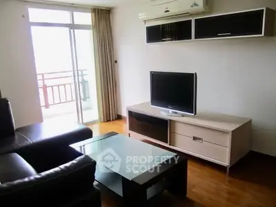 Modern living room with sleek furniture and balcony access in a stylish apartment.