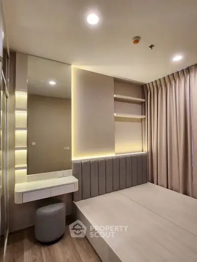Modern bedroom with sleek design, built-in shelves, and ambient lighting for a cozy atmosphere.
