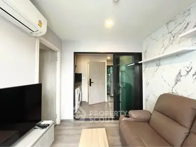 Modern living room with marble accent wall and sleek furniture in a stylish apartment.