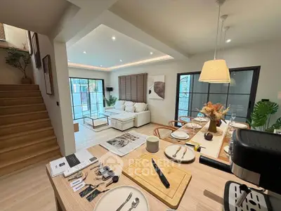 Modern open-plan living and dining area with stylish decor and natural light.