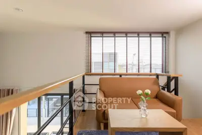 Modern loft living room with cozy sofa and large window view