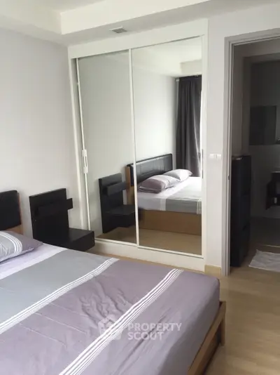 Modern bedroom with mirrored wardrobe and sleek design